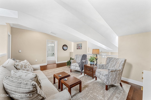 living room with vaulted ceiling and wood-type flooring