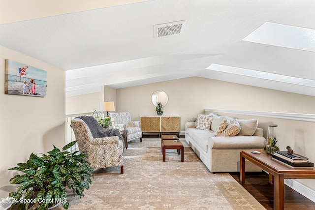 living room featuring light hardwood / wood-style flooring and lofted ceiling