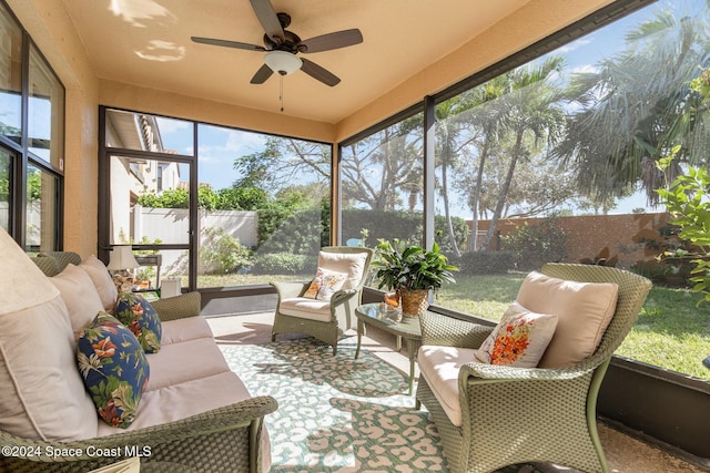 sunroom / solarium featuring ceiling fan and an outdoor living space