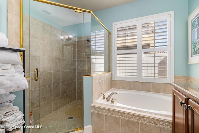 full bathroom with a garden tub, vanity, visible vents, and a shower stall