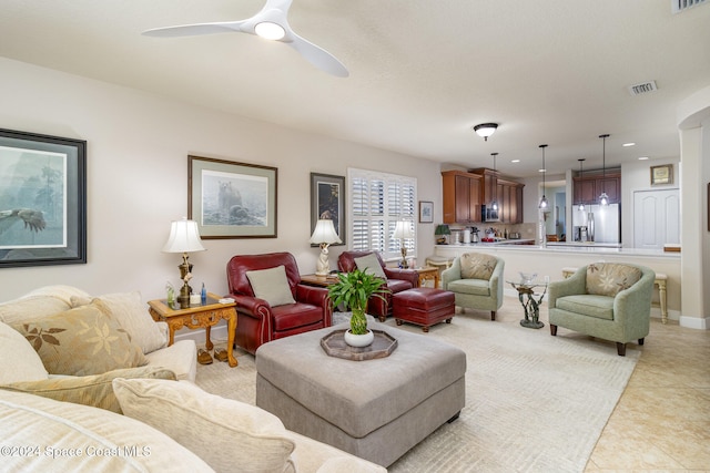 tiled living room with ceiling fan