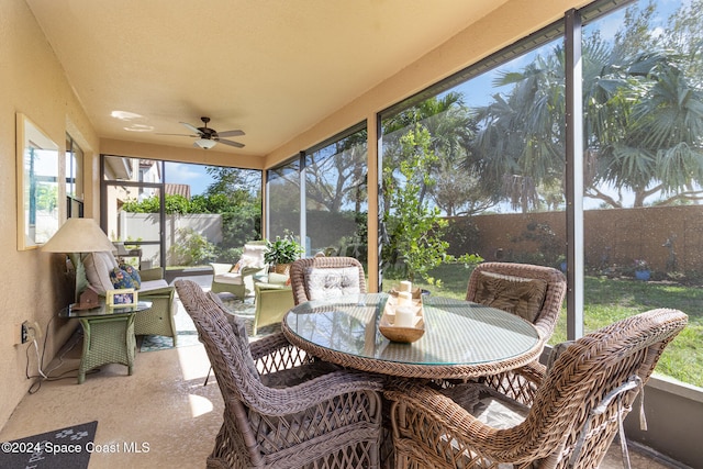 sunroom featuring ceiling fan