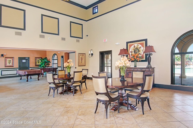 tiled dining room featuring a high ceiling and pool table