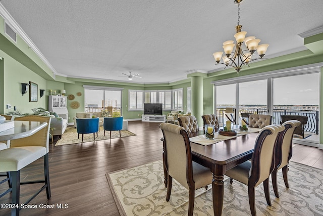 dining room with ornamental molding, hardwood / wood-style floors, a textured ceiling, and ceiling fan with notable chandelier