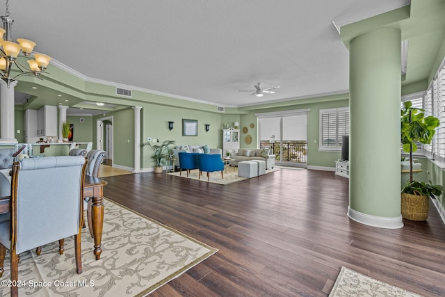 dining area featuring ornate columns, hardwood / wood-style floors, crown molding, a textured ceiling, and ceiling fan with notable chandelier