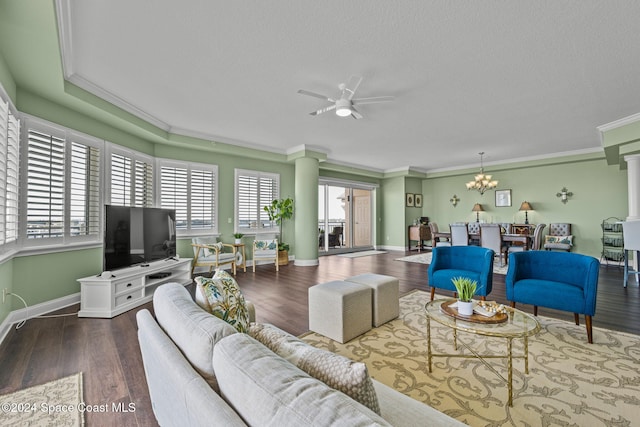 living room with a textured ceiling, wood-type flooring, ornamental molding, and ceiling fan with notable chandelier