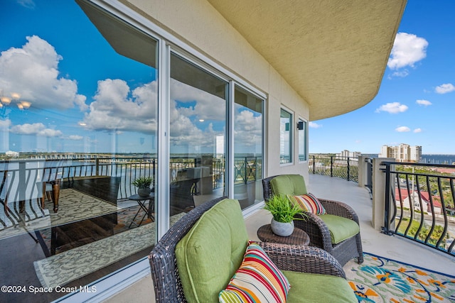 balcony featuring a water view