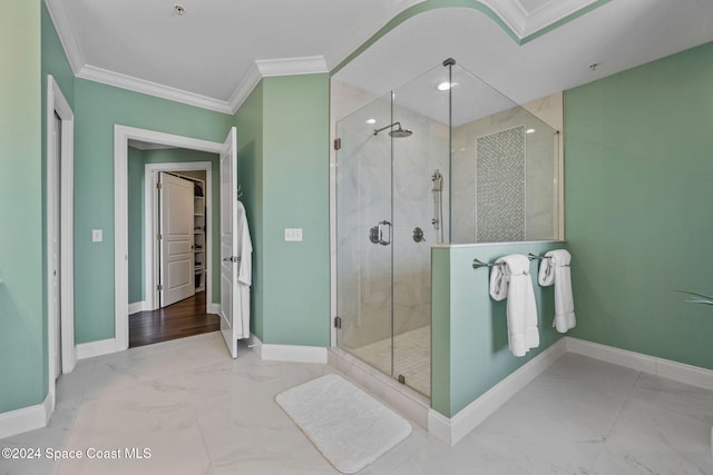 bathroom with crown molding and a shower with shower door