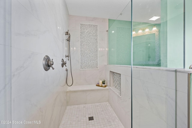 bathroom with a tile shower