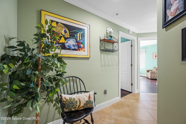 hall featuring crown molding and light hardwood / wood-style floors