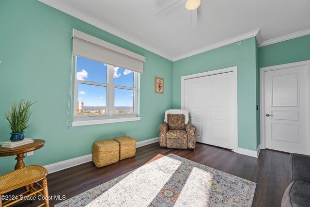 living area featuring crown molding, ceiling fan, and dark hardwood / wood-style flooring