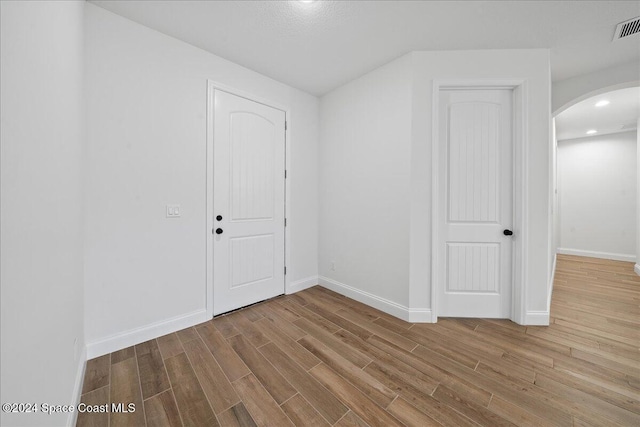 spare room featuring light wood-type flooring