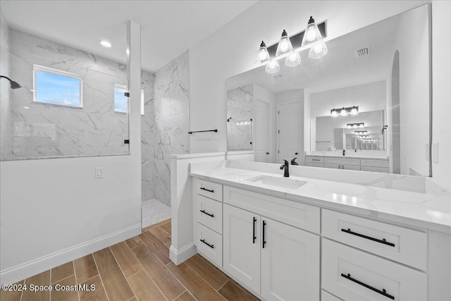 bathroom featuring vanity and tiled shower