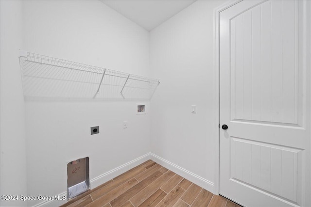 washroom featuring electric dryer hookup, hookup for a washing machine, and hardwood / wood-style floors