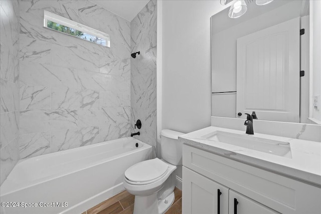 full bathroom with toilet, vanity, tiled shower / bath combo, and hardwood / wood-style flooring