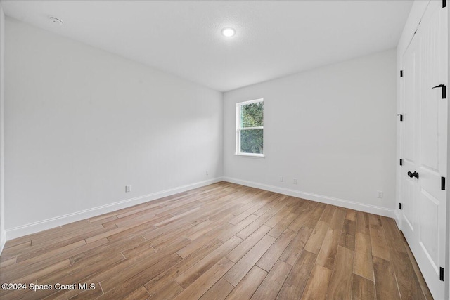 unfurnished room with light hardwood / wood-style floors