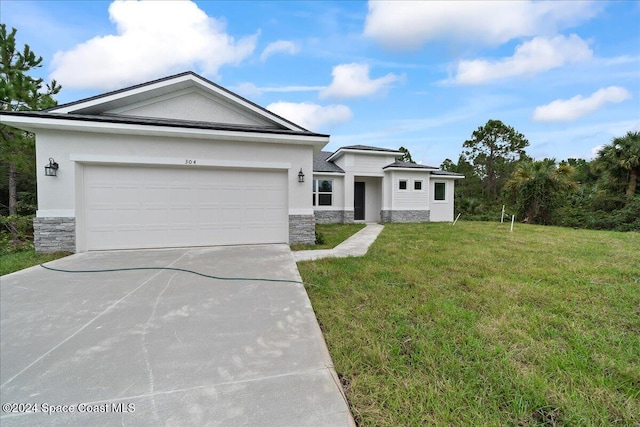 view of front facade featuring a garage and a front lawn