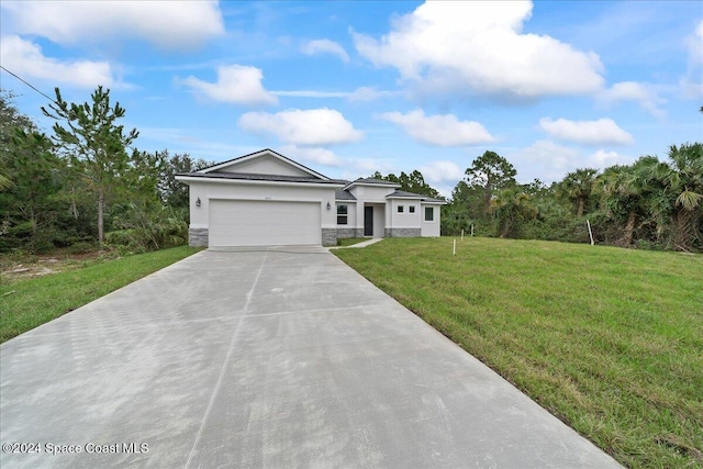 view of front facade with a front yard and a garage