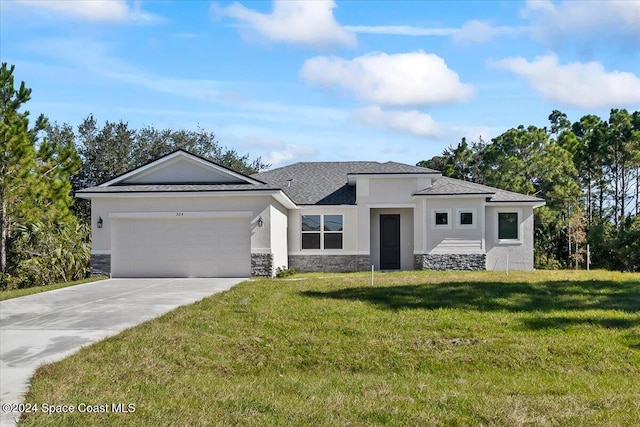 view of front of house featuring a front yard and a garage