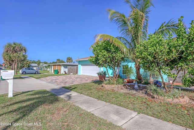 view of front of house featuring a front yard and a garage