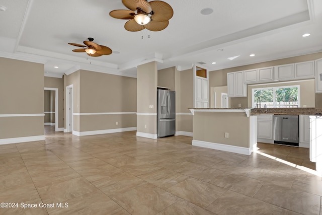 kitchen with ornamental molding, appliances with stainless steel finishes, white cabinetry, and ceiling fan