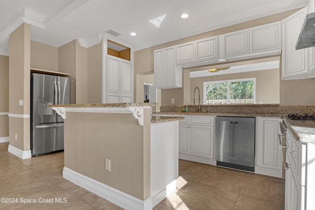 kitchen with appliances with stainless steel finishes, visible vents, light stone countertops, and white cabinets