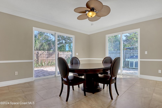 dining room with light tile patterned flooring, a healthy amount of sunlight, ceiling fan, and ornamental molding