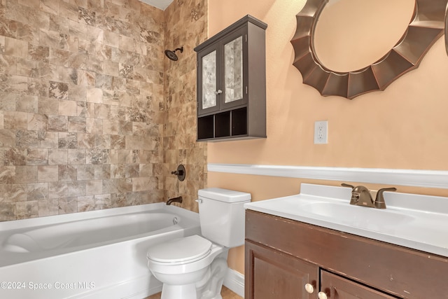 full bathroom featuring vanity, tiled shower / bath combo, and toilet