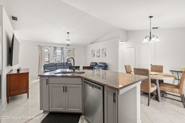 kitchen featuring a center island with sink, dishwasher, sink, gray cabinetry, and decorative light fixtures