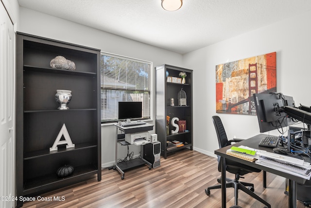 office space featuring a textured ceiling and wood-type flooring