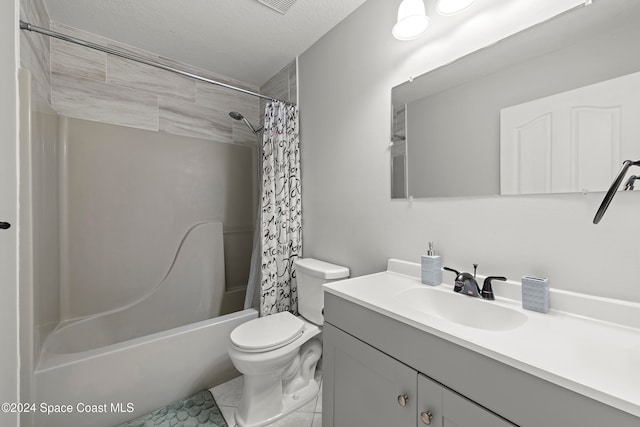 full bathroom with a textured ceiling, toilet, shower / bath combo, vanity, and tile patterned flooring