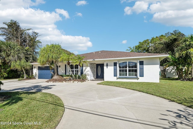 ranch-style house featuring a front yard and a garage