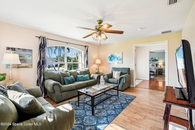 living room featuring light wood-type flooring and ceiling fan