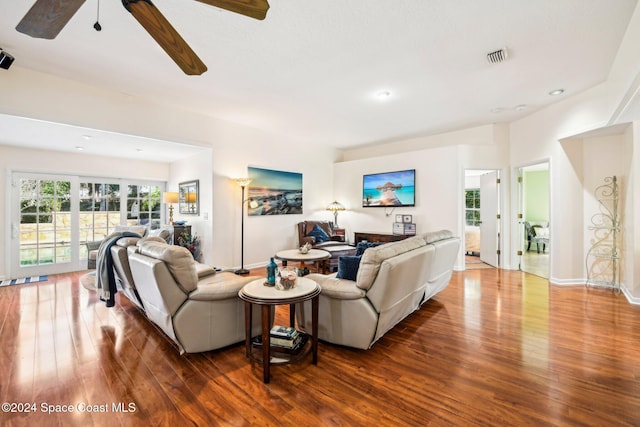 living room with wood-type flooring and ceiling fan