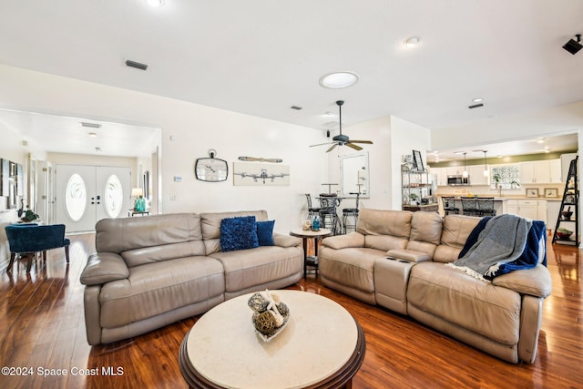 living room featuring hardwood / wood-style floors, french doors, and ceiling fan