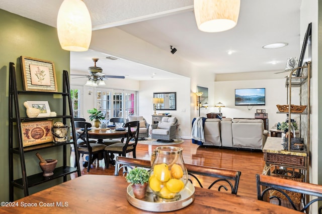 dining area with wood-type flooring and ceiling fan