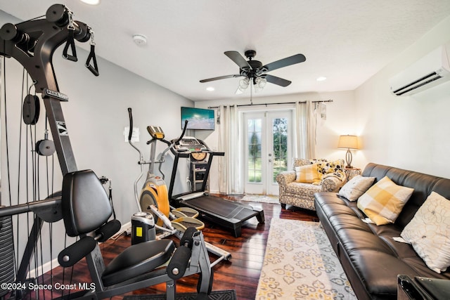 exercise area featuring french doors, ceiling fan, dark hardwood / wood-style floors, and a wall unit AC