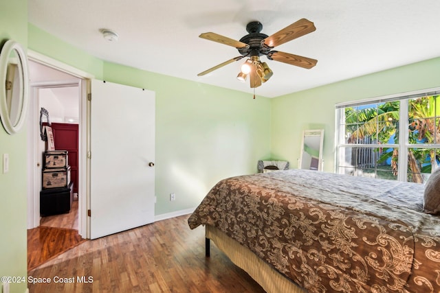 bedroom with ceiling fan and hardwood / wood-style floors