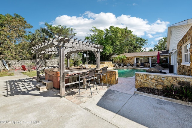 view of patio / terrace featuring a pool with hot tub and a pergola