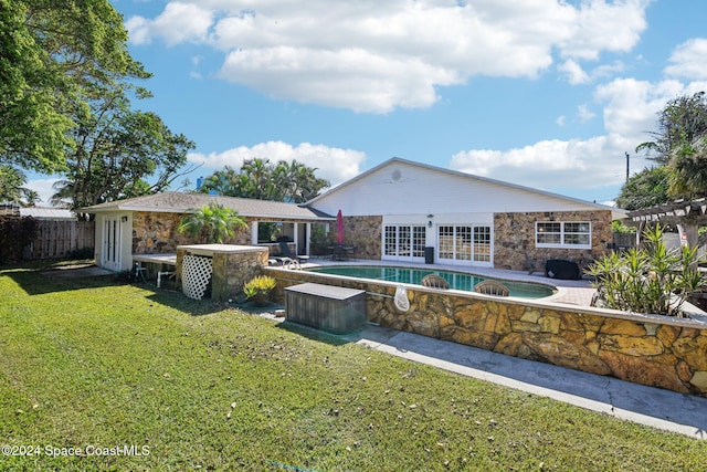 view of pool with a patio area and a yard