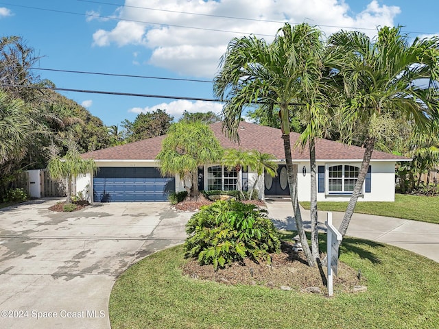 single story home with a front lawn and a garage