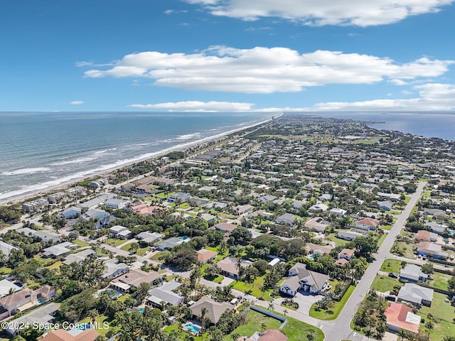 bird's eye view with a water view and a beach view