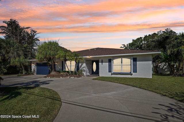 view of front of property with a lawn and a garage