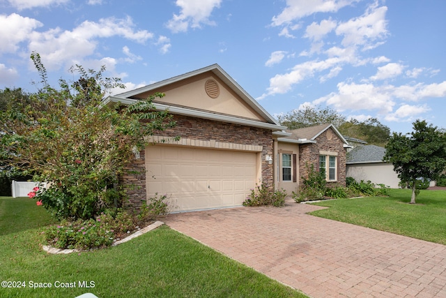 view of front of home with a front lawn and a garage