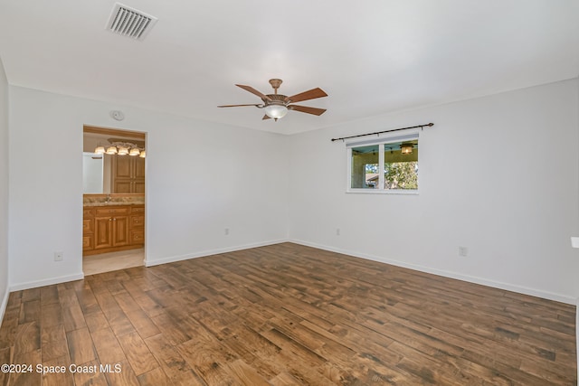 unfurnished room featuring ceiling fan, sink, and dark hardwood / wood-style flooring