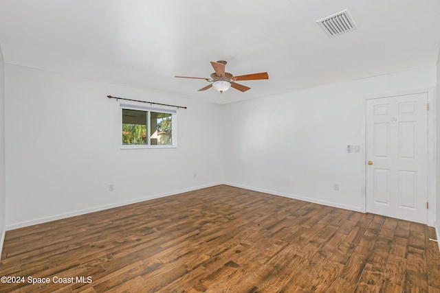 unfurnished room featuring ceiling fan and dark hardwood / wood-style flooring