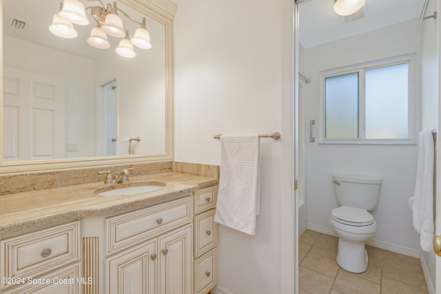 bathroom with vanity, toilet, a shower, and tile patterned flooring