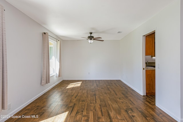 unfurnished room featuring ceiling fan and dark hardwood / wood-style flooring