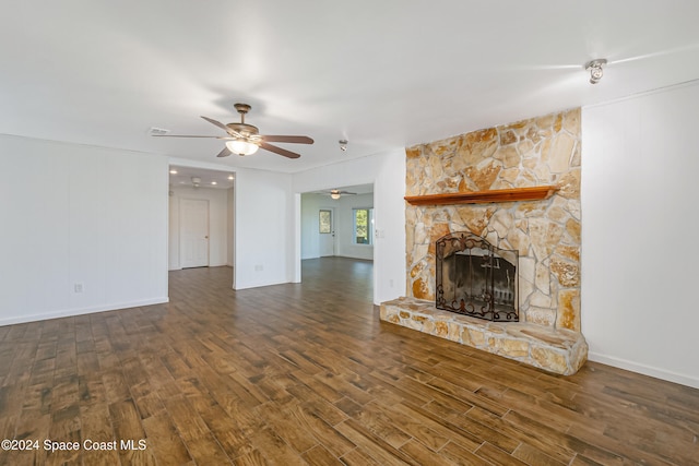 unfurnished living room with dark wood-type flooring, ceiling fan, and a fireplace