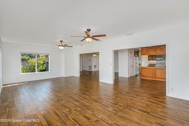 unfurnished living room with dark wood-type flooring and ceiling fan